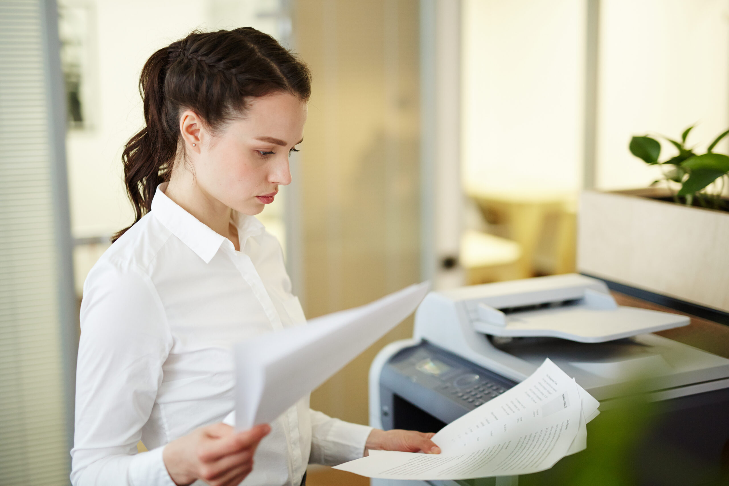 Person working calmly at a desk after fixing printer issues